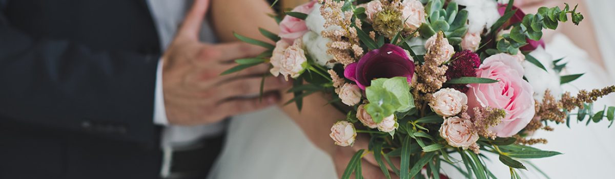 The bride is holding a bouquet of flowers.